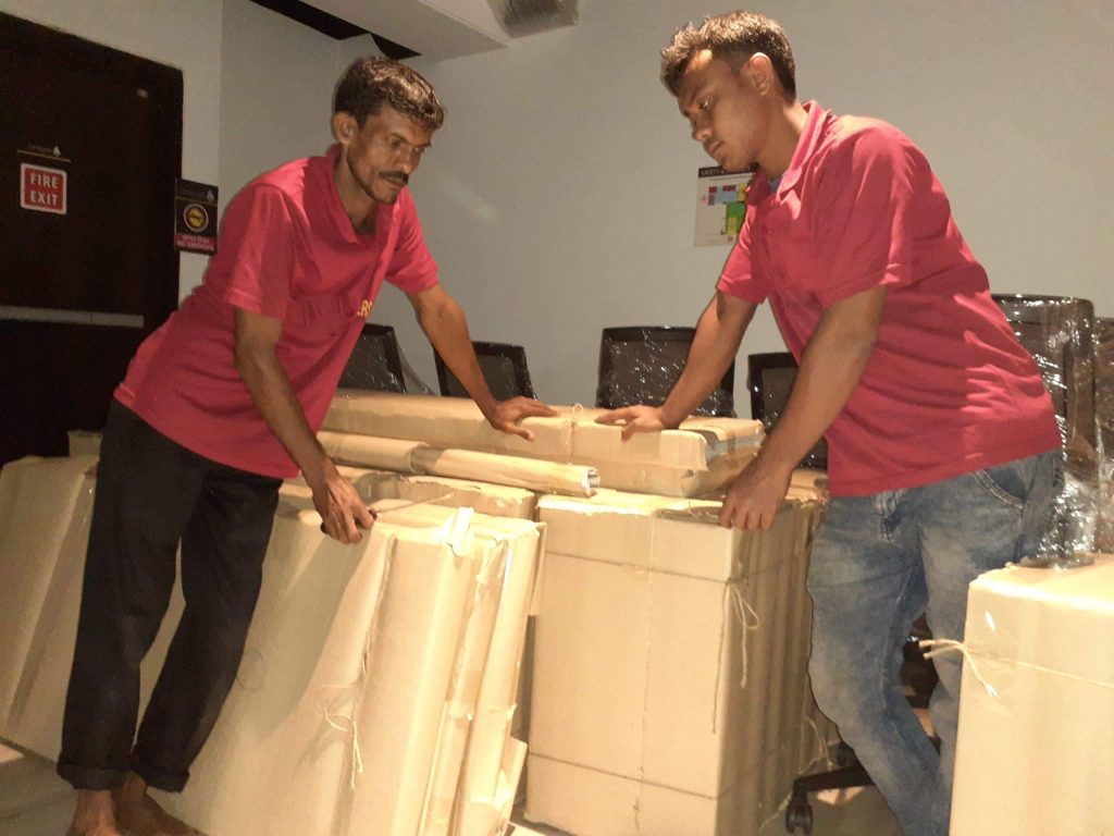 Two man are moving or holding some home accessories for moving and shifting.