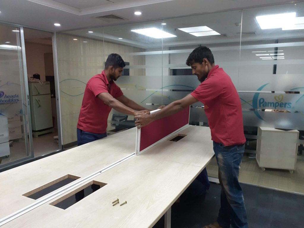 Two guy moving the table partwise