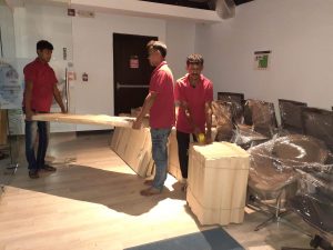 Two guy from "Doha Shifting" moving house accessories for relocation.